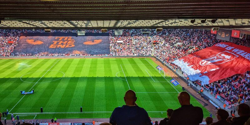 Sunderland's Stadium of Light with huge flags reading THIS IS WEARSIDE and 'TIL THE END