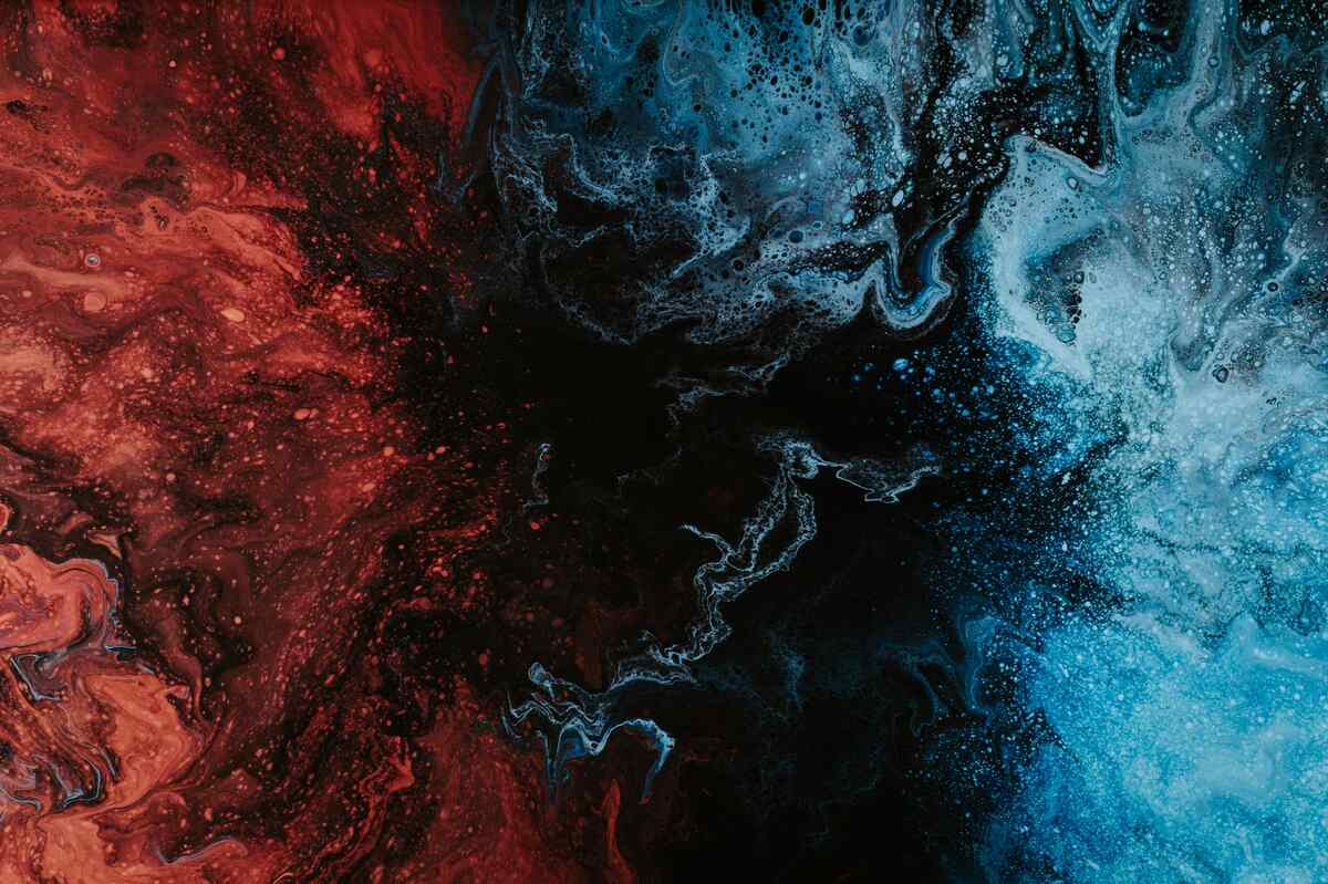 An abstract image featuring red, blue, and black suggesting liquid in motion.