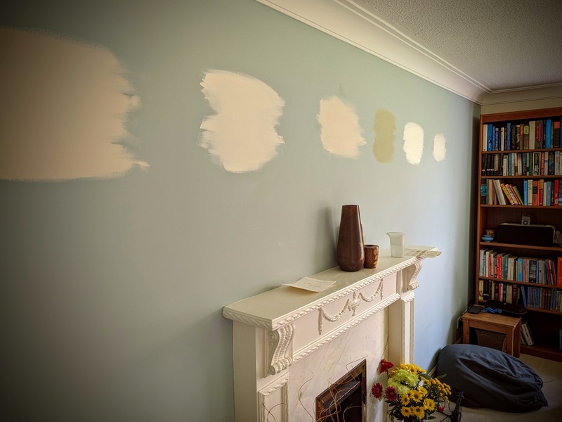 Stylized photo of paint swatches on a wall in a lounge
